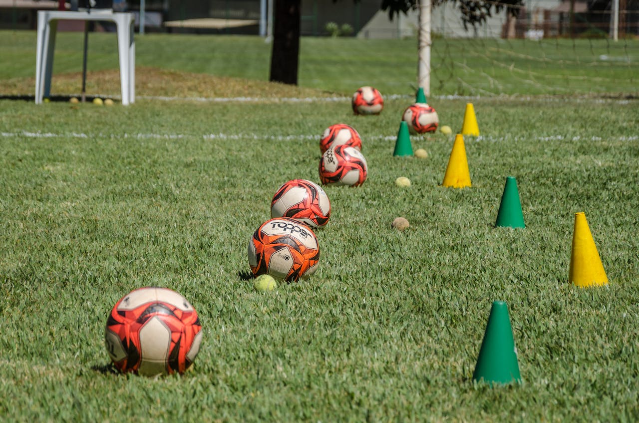 The Art of Drawing Readers In: Your attractive post title goes here Soccer training equipment arranged on grass in Brasília, Brazil, featuring balls and cones.